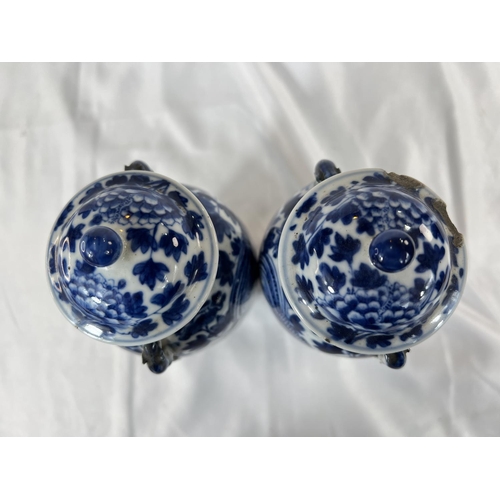 463 - A pair of Chinese 18th/19th Century lidded vases with marks for Kangxi period, blue and white with b... 