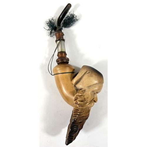 47 - An amber and Meerschaum pipe with silver mount, depicting an arab man's head with beard and turban; ... 