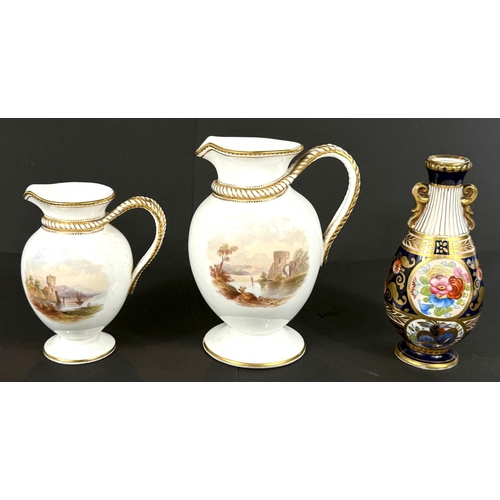 481 - Two - 19th century graduating baluster jugs decorated with polychrome landscapes, heights 16 + 30 cm... 