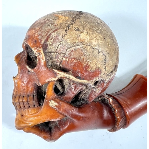 49 - A cased amber and Meerschaum pipe in the form of a skull with chased silver mounts, length 20cm.