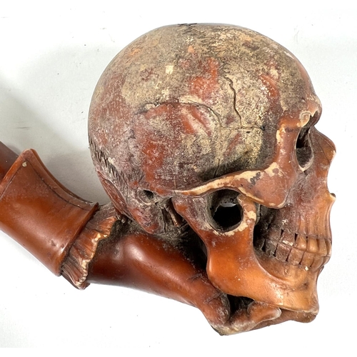 49 - A cased amber and Meerschaum pipe in the form of a skull with chased silver mounts, length 20cm.