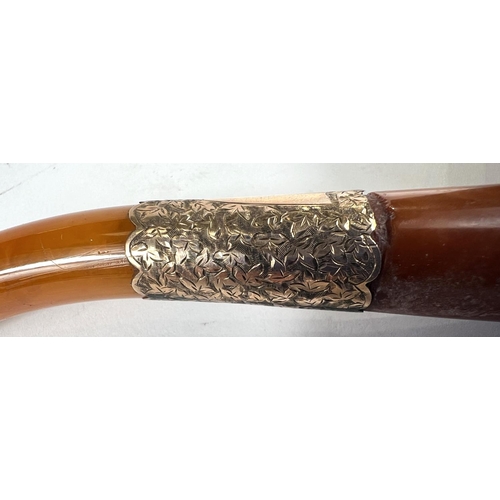 49 - A cased amber and Meerschaum pipe in the form of a skull with chased silver mounts, length 20cm.