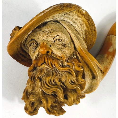 50 - A large cased amber and Meerschaum pipe depicting a bearded man's head with feathered hat (stem slig... 