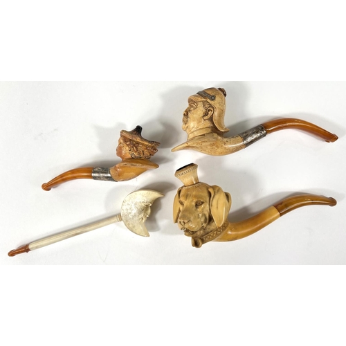 52 - 4 cased amber and Meerschaum pipes depicting Prussian officer's head,  man in the moon, woman's head... 