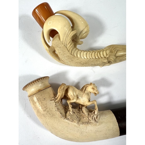 53 - 3 cased amber and Meerschaum pipes depicting a horse, a large claw and a ladies head (broken stem)