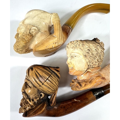 54 - 3 amber and Meerschaum pipes, 2 cased, depicting:- Turk's head with turban; bearded man's head and a... 