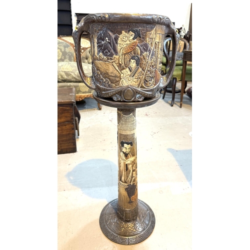 547 - A Bretby style jardiniere decorated with oriental figures, with matching stand (cracked)