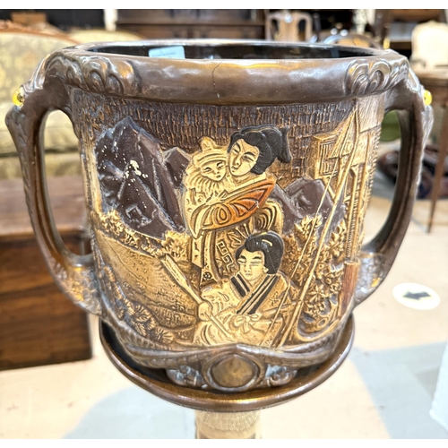 547 - A Bretby style jardiniere decorated with oriental figures, with matching stand (cracked)