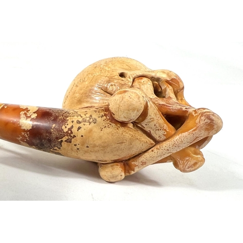 56 - 2 cased amber and Meerschaum pipes depicting skull and crossbones and black man's head.