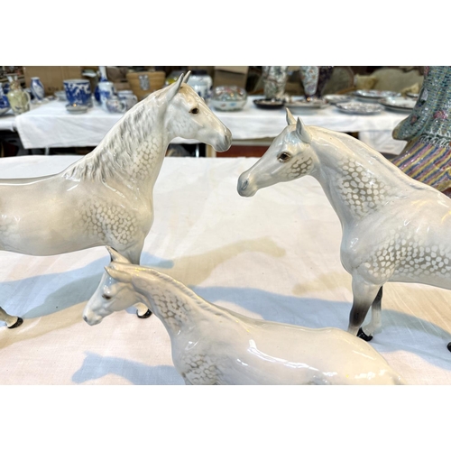 568 - BESWICK, a group of 3 dappled horses, 31cm, 28cm and 20cm; another horse