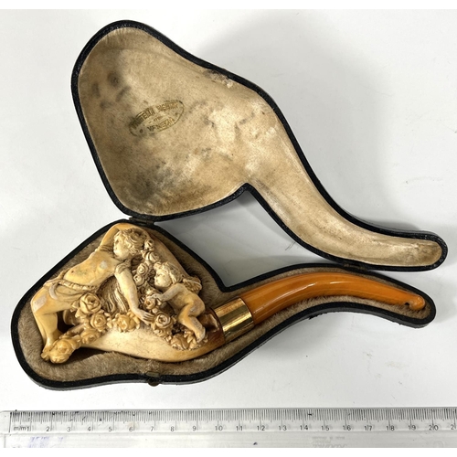 57 - A cased amber and Meerschaum pipe with extensive relief decoration of a reclining woman in flowers w... 