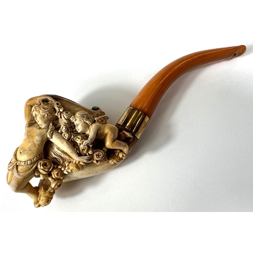 57 - A cased amber and Meerschaum pipe with extensive relief decoration of a reclining woman in flowers w... 