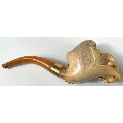 57 - A cased amber and Meerschaum pipe with extensive relief decoration of a reclining woman in flowers w... 