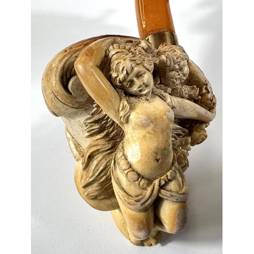 57 - A cased amber and Meerschaum pipe with extensive relief decoration of a reclining woman in flowers w... 