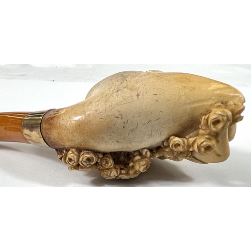 57 - A cased amber and Meerschaum pipe with extensive relief decoration of a reclining woman in flowers w... 