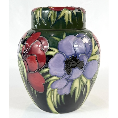 580 - A Moorcroft green ground ginger jar in the Anemone pattern height 14cm (mark to base indicates 'seco... 