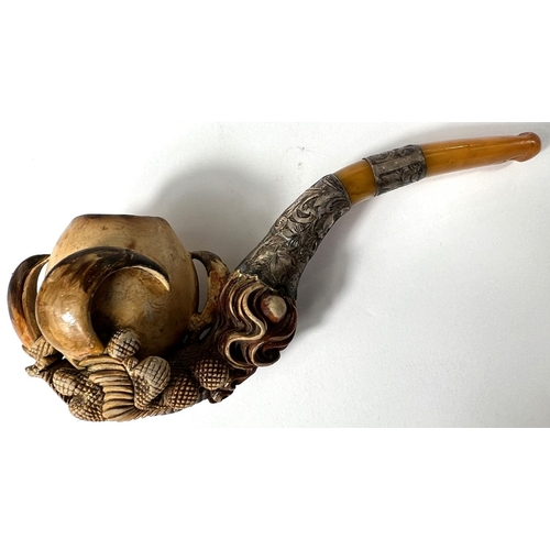 65 - A cased amber and Meerschaum pipe with chased silver mounts & a very realistic claw & egg bo... 