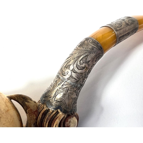 65 - A cased amber and Meerschaum pipe with chased silver mounts & a very realistic claw & egg bo... 