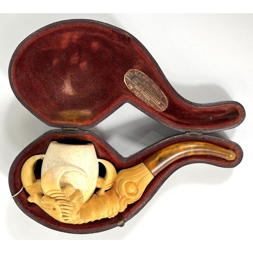 69 - A cased amber and Meerschaum pipe in the form of a claw & egg, length 16cm.