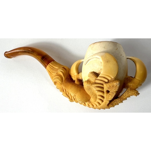 69 - A cased amber and Meerschaum pipe in the form of a claw & egg, length 16cm.