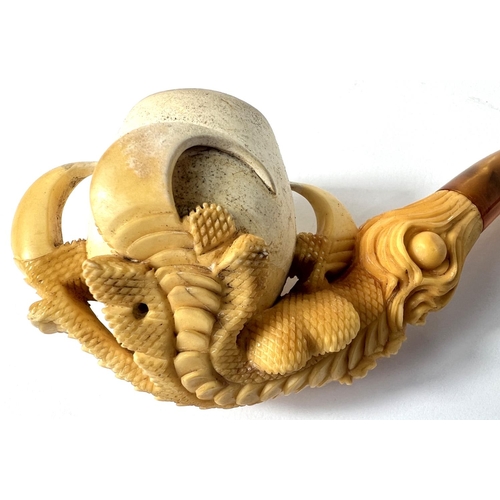 69 - A cased amber and Meerschaum pipe in the form of a claw & egg, length 16cm.