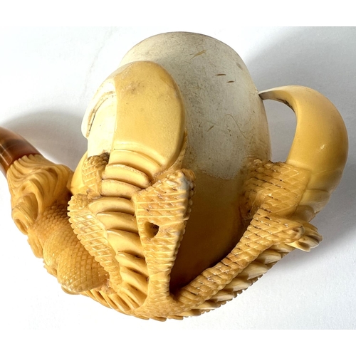 69 - A cased amber and Meerschaum pipe in the form of a claw & egg, length 16cm.