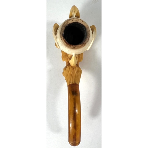 69 - A cased amber and Meerschaum pipe in the form of a claw & egg, length 16cm.