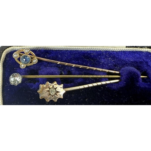 702 - Six gem-set stick pins; a tie clip stamped 