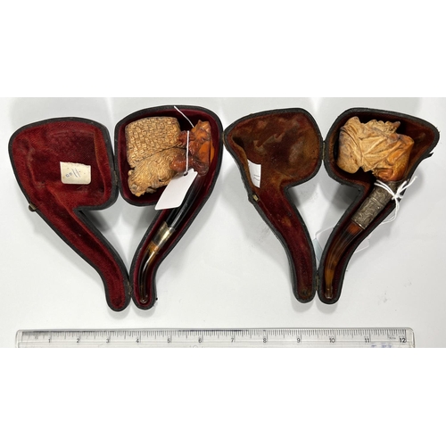 71 - 2 cases amber and Meerschaum pipes, one in the form of a bear with a basket on its back, length 16cm... 