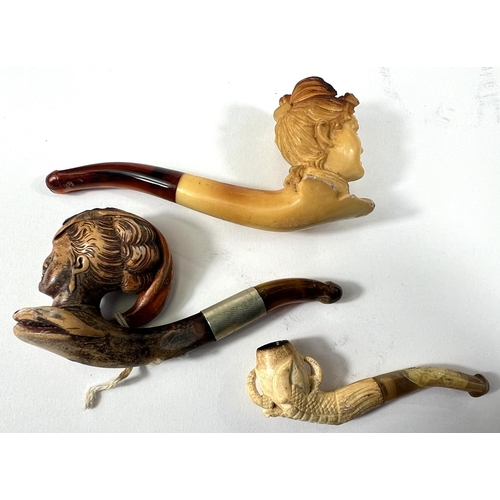 72 - 3 small amber and Meerschaum pipes, including a woman's head, cased; egg & claw, cased; and woma... 