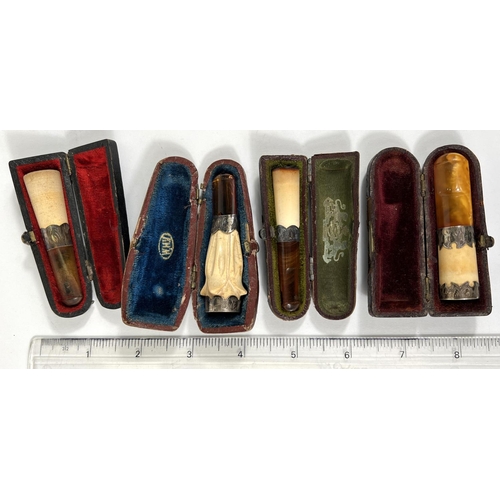 74 - 4 cased amber and Meerschaum cigar holders with silver mounts.