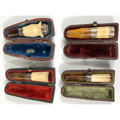 74 - 4 cased amber and Meerschaum cigar holders with silver mounts.