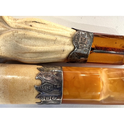 74 - 4 cased amber and Meerschaum cigar holders with silver mounts.