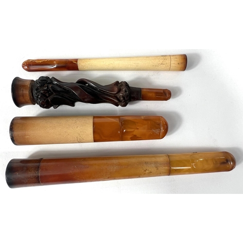 76 - 4 cased decorative amber and Meerschaum cigar/cigarette holders.