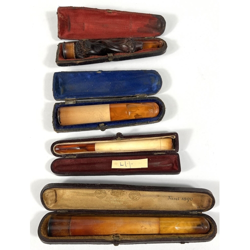 76 - 4 cased decorative amber and Meerschaum cigar/cigarette holders.