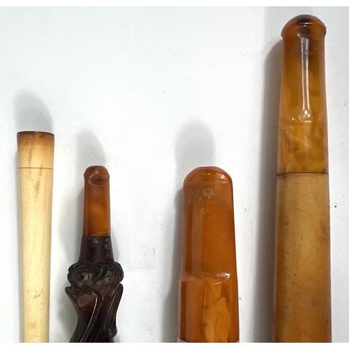 76 - 4 cased decorative amber and Meerschaum cigar/cigarette holders.