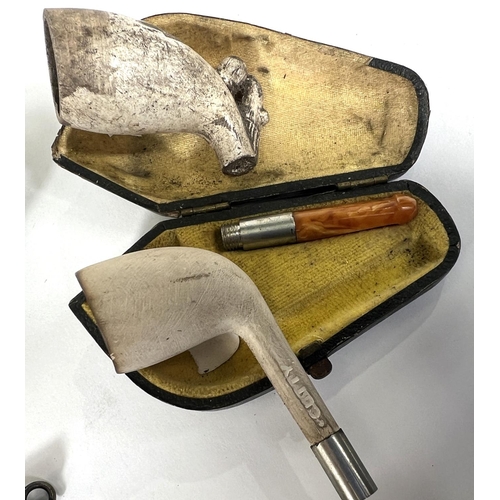 78 - A small cased amber and Meerschaum pipe, and ceramic pipe stand; a white metal cigarette holder case... 