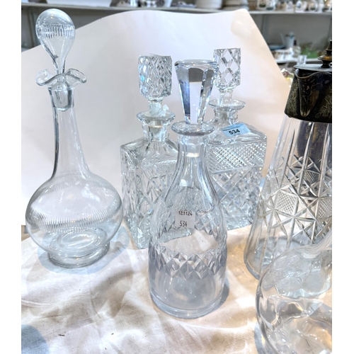 534 - A selection of cut glass decanters and a claret jug