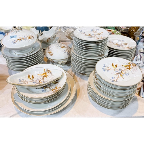 540 - A large Continental dinner service decorated in polychrome with flowering branches (approx. 70 piece... 