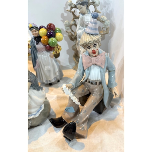 542 - A Leonardo figure, seated clown with playing cards; a Royal Doulton style balloon seller; a Lladro G... 