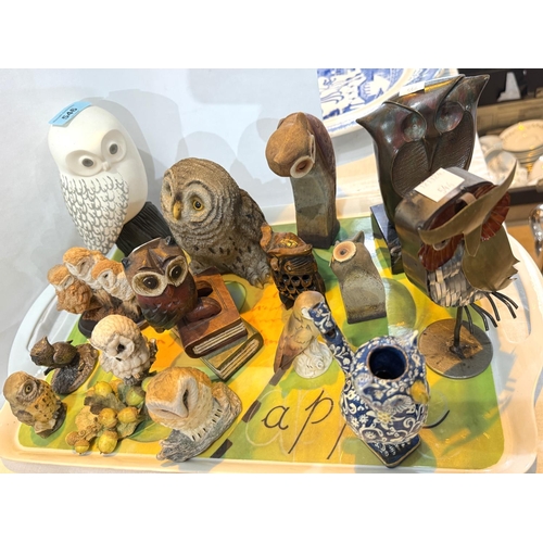 546 - A collection of owls in pottery resin, metal and wood.