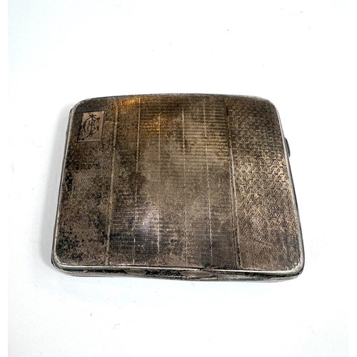 705 - A 1930's silver cased engine turned cigarette case and a silver watch Albert chain