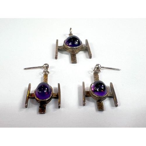 711 - A modernist silver amethyst set suite of pendant and earrings.