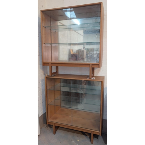 1000 - A pair of mid 20th century light oak, glass sliding door, book cases.