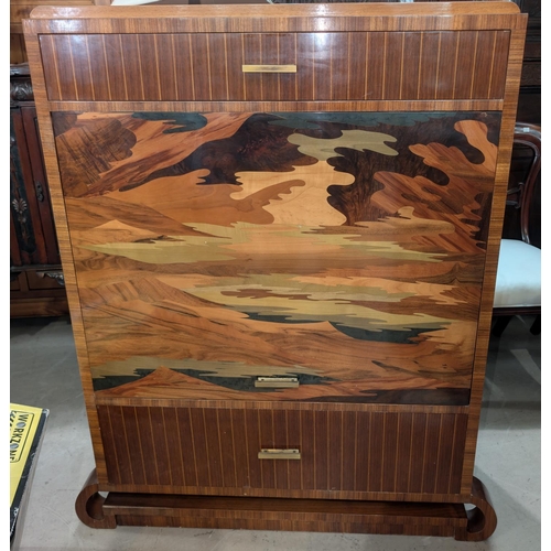 1011 - An Art Deco style inlaid converted drinks cabinet with up and over front door, drawers above and bel... 