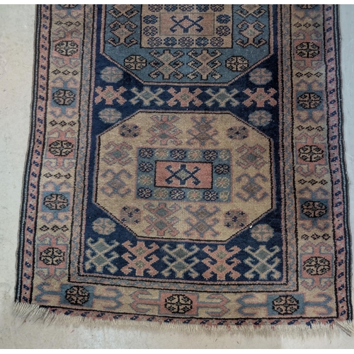 1014 - A blue ground hand knotted Persian runner with 5 octagonal medallions to the field, length 250 x wid... 