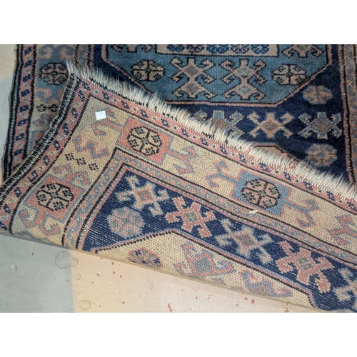 1014 - A blue ground hand knotted Persian runner with 5 octagonal medallions to the field, length 250 x wid... 