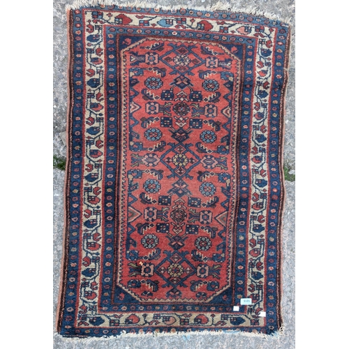 1015 - A mid 20th century red ground hand knotted Persian rug with Herati motifs to the field, 117 x 77cm.