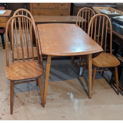 978 - An Ercol light elm and beech dining suite comprising oval drop leaf table and 4 hoop and stick back ... 