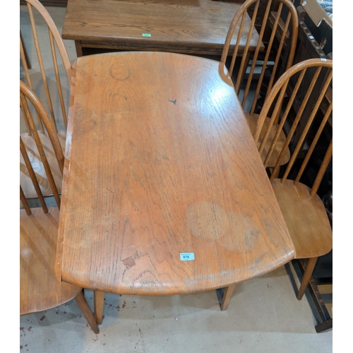 978 - An Ercol light elm and beech dining suite comprising oval drop leaf table and 4 hoop and stick back ... 